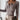 
A gray fitted long sleeve women's blouse with a ribbed texture, featuring a henley neckline. The top is designed to accentuate the shoulder and waist area. Modeled in an XL size.