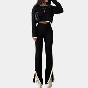 Unisex spring sweater featuring a white ribbed knit design with a distinct green collar, shown in a black color variant, size large, worn by a person.