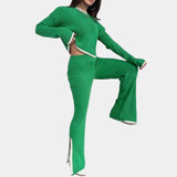White ribbed knit top with a green collar worn by a person, styled with jeans.