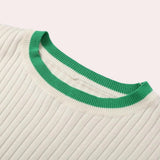 White ribbed knit top with a distinctive green collar, featuring long sleeves and a subtle pattern, designed as a unisex spring sweater.