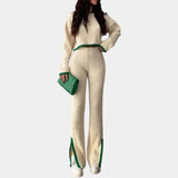 Unisex white ribbed knit top with a distinctive green collar, featuring long sleeves and a comfortable fit.