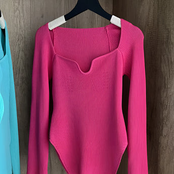 White ribbed scoop neck long sleeve bodysuit in rose color, displayed on a clothes hanger.