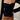 White ribbed scoop neck long sleeve bodysuit for women, shown in black color, size XL, highlighting the fit around the shoulders, arms, and waist.