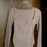 White ribbed scoop neck long sleeve bodysuit in khaki on clothes hanger, showcasing its beige color and soft textile with fashion-forward design, tailored for women's fashion in size XL.