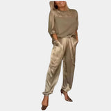Women's white satin jumpsuit and khaki cargo pants set featuring a collared design with pockets and a fashion-forward appeal, modeled by a woman wearing 2XL in a stylish loungewear ensemble.