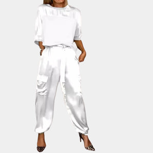 White satin jumpsuit and cargo pants set for women in size 2XL, showcasing a stylish blend of loungewear and workwear elements with a focus on fashion design, featuring long sleeves, a defined waist, and a sleek, formal appearance.