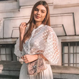 White sheer polka dot bishop sleeve blouse featuring a casual chic design, with a focus on the elegant sleeves and neckline, suitable for formal and casual occasions.
