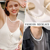 A woman smiling and wearing a white shell choker necklace, complemented by casual outerwear, showcasing bohemian beach jewelry fashion.