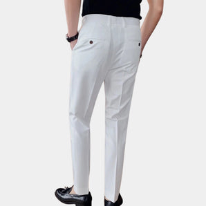White slim fit men's dress pants designed for business and formal wear, showcasing a lightweight fabric and tailored fit, focusing on the waist, thigh, and leg areas.