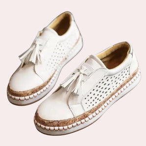 White tassel loafers for women featuring breathable perforated design, suitable for casual and walking wear.