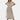 White V-neck midi lace dress with short sleeves in a boho summer style, showcasing intricate lace detailing on the shoulders and arms, with a fitted waist and flowing skirt.