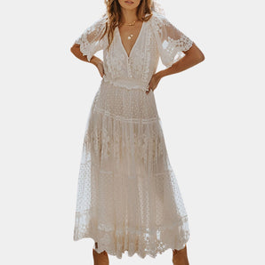 White V-neck midi lace dress with short sleeves in a boho summer style, showcasing intricate lace detailing on the shoulders and arms, with a fitted waist and flowing skirt.