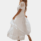 White V-neck midi lace dress with short sleeves, featuring a boho summer style, worn by a woman.