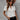 White V-neck short sleeve blouse for women, designed as elegant summer office wear, displayed on a mannequin. The blouse features a crisp white color, short sleeves, and a V-neckline, suitable for formal or casual office settings.