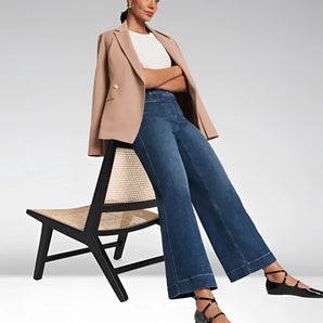 Wide-leg high-waisted jeans paired with a neutral blazer, showcasing a casual chic outfit with visible footwear and dress shirt sleeves.