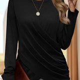 
A woman wearing a wine red asymmetrical long sleeve wrap tunic top, styled with jeans. The top is part of women's fall fashion, available in size 2XL.