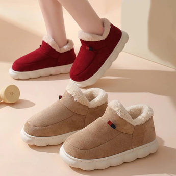 
A pair of winter slip-on shoes in white with pink and red accents, featuring a fleece lining, insulated and waterproof design, suitable for walking and fashion.