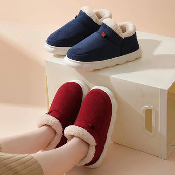 White winter slip-on shoes featuring a fleece-lined interior and waterproof exterior, designed for comfort and outdoor activities.