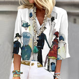 Women's artistic print blouse in a multicolor design, featuring a unique pattern with green accents. The blouse is styled with a fashionable neckline and sleeves, suitable for a 3XL size. The fabric has a stylish and trendy appearance, ideal for making a bold fashion statement.