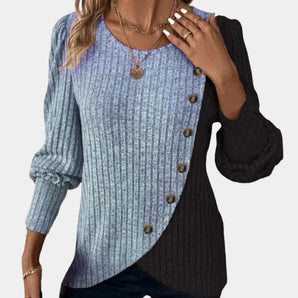 
A blue, extra-large women's asymmetric two-tone sweater featuring button details, showcasing a stylish fashion look with emphasis on the shoulder and neck areas.