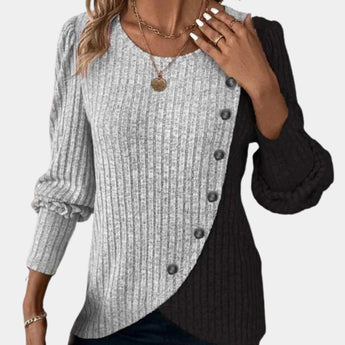 
A women's gray asymmetric two-tone sweater in size XL featuring button details on the shoulder area, with a long sleeve design and a collar.
