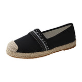 Black women's beaded slip-on loafers designed as elegant summer flats, featuring intricate beadwork and leather construction, ideal for casual and stylish outdoor wear.
