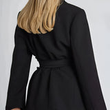 Women's beige belted blazer with tailored fit, featuring long sleeves, a collar, and a defined waist, suitable for a polished and professional look.