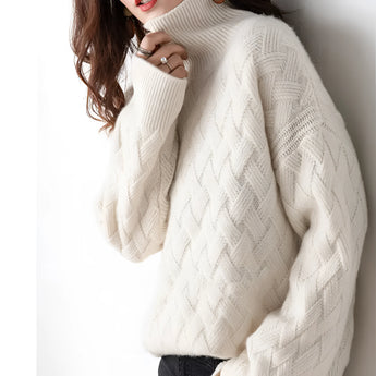 Women's beige chunky knit turtleneck sweater with long sleeves, designed in an oversized style for winter fashion.
