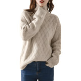 
A woman wearing a beige chunky knit turtleneck sweater showcasing an oversized fit, designed for winter fashion. The sweater features a high collar and long sleeves, emphasizing a cozy and stylish look.
