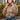 Women's beige cropped puffer jacket in khaki color, showcasing insulated winter style with a focus on outerwear design elements such as the shoulder and sleeve details, photographed to highlight the texture and fashion-forward appeal.