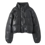 Women's beige cropped puffer jacket with a high collar and long sleeves, showcasing an insulated winter style.