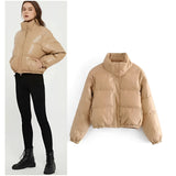 Beige cropped puffer jacket for women featuring insulated material, long sleeves, and a high collar, designed for winter fashion.