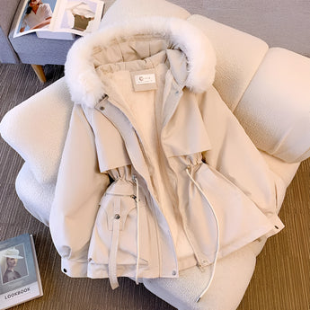 
Image of a women's beige insulated winter parka with a fur-lined hood. The coat features long sleeves and a stylish design suitable for cold weather.