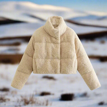 Women's beige high collar warm fleece winter jacket with long sleeves, made from woolen textile, displayed against a wooden background.