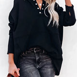 A woman wearing a black XXL casual buttoned pullover hoodie with ribbed cuffs, paired with jeans.