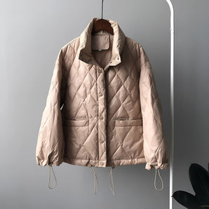 Women's beige quilted puffer jacket with drawstring, featuring a lightweight design, long sleeves, and a high collar.