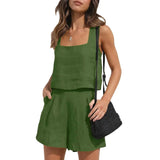 A woman wearing a dark green two-piece set including a casual tank top and shorts, showcasing a comfortable and relaxed fit perfect for a casual day out.