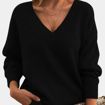 
A black oversized V-neck sweater in a cozy knit fabric, designed for women, displayed in the 2XL size, showcasing the shoulder and sleeve details.