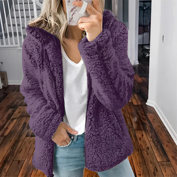 Women's purple plush teddy coat in 5XL size, featuring a fuzzy texture, designed for winter fashion. The coat has long sleeves and a stylish neckline, combining both comfort and warmth.