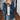 Women's beige plush teddy coat, showcasing a soft, fuzzy texture designed for winter warmth. The coat features long sleeves, a high neckline, and a stylish, fashionable fit.
