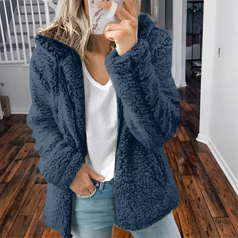 Women's beige plush teddy coat, showcasing a soft, fuzzy texture designed for winter warmth. The coat features long sleeves, a high neckline, and a stylish, fashionable fit.