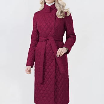 
A red long belted insulated trench coat with a quilted design, featuring a collar and full sleeves, displayed on a model. The coat is styled to have a slim fit and is part of women's outerwear collection.