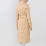 Women's long beige quilted coat with a belted waist, featuring an insulated slim trench design, complete with a collar and sleeves.