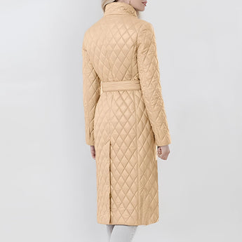 Women's long beige quilted coat with a belted waist, featuring an insulated slim trench design, complete with a collar and sleeves.