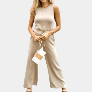 Women's beige sleeveless jumpsuit in apricot color, size 2XL, showcasing a casual summer style with a flattering waistline and a simple neckline.