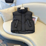 Women's beige sleeveless puffer vest, lightweight and insulated, designed for winter wear.