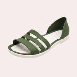 Women's beige flat sandals with strappy design, featuring a delicate pearl ankle bracelet, shown in size 40.