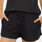 Women's black athletic shorts set shown in a quick-dry, breathable fabric, featuring a stylish design ideal for activewear.
