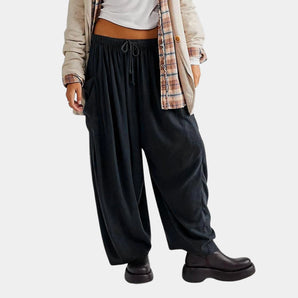 Women's black corduroy wide-leg drawstring pants styled for fall fashion, featuring a loose and comfortable fit.