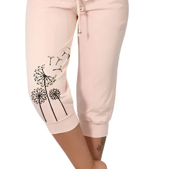 Women's black capri pants with white dandelion print, modeled by a person wearing a pink top, suitable for casual summer wear, lightweight and comfortable fit in size 5XL.